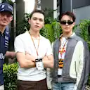 Vernon and Dino from Seventeen posing with Red Bull’s Max Verstappen and Yuki Tsunoda