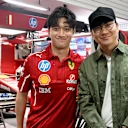 JJ Lin poses with Zhou Guanyu in the Ferrari garage