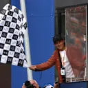Argentine footballer and World Cup winner Paulo Dybala waves the chequered flag during the F1 Grand Prix of Netherlands. Swipe for more images