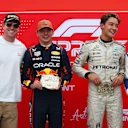 Tara Davis-Woodhall and Hunter Woodhall awarded the Sprint top three with their buckle-style trophies