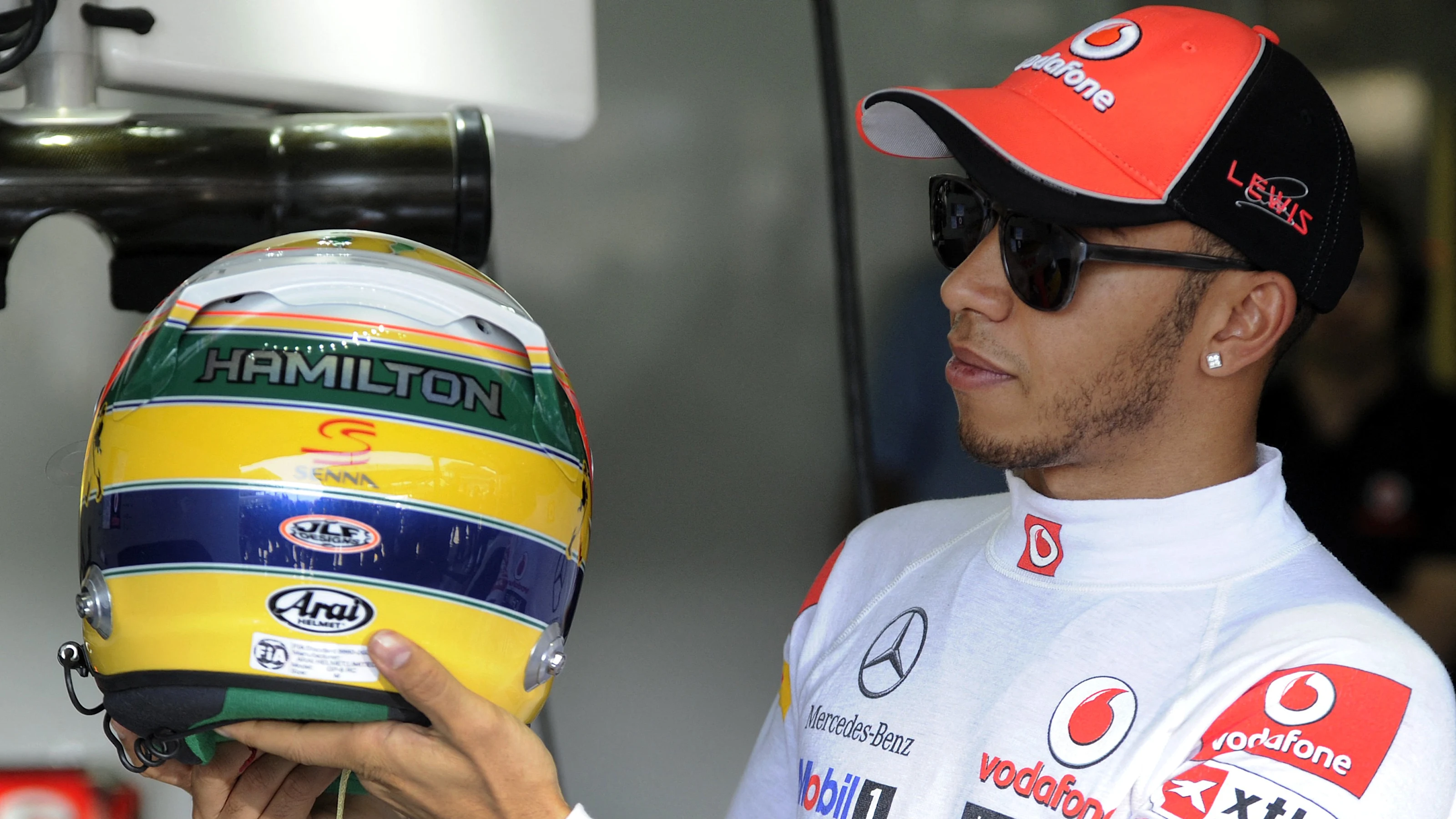 British Formula One driver Lewis Hamilton of Mc Laren holds his new helmet, which pays tribute to