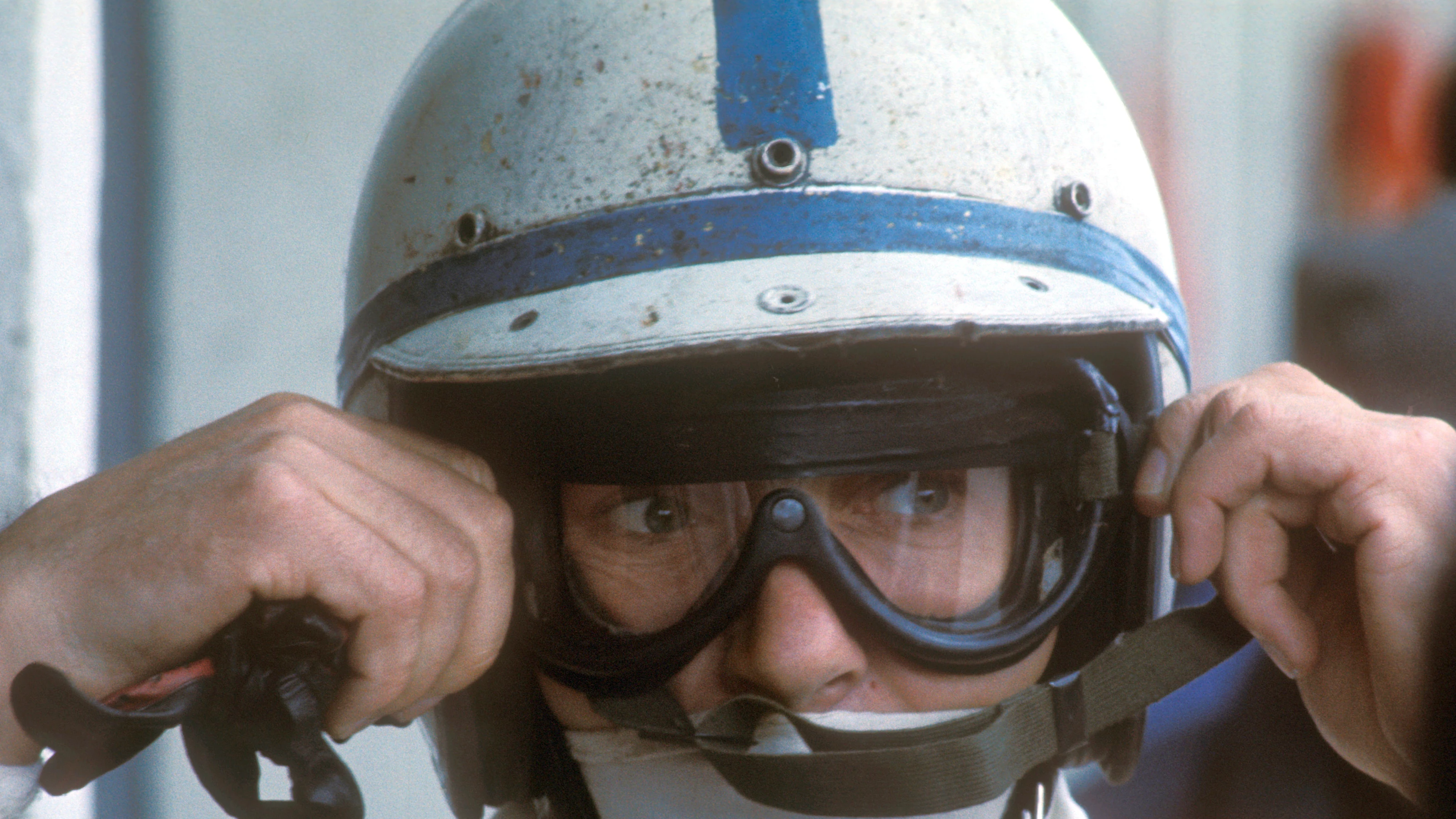 John Surtees of Great Britain, driver of the #7 Honda Racing Honda RA273 Honda V12 adjusts his