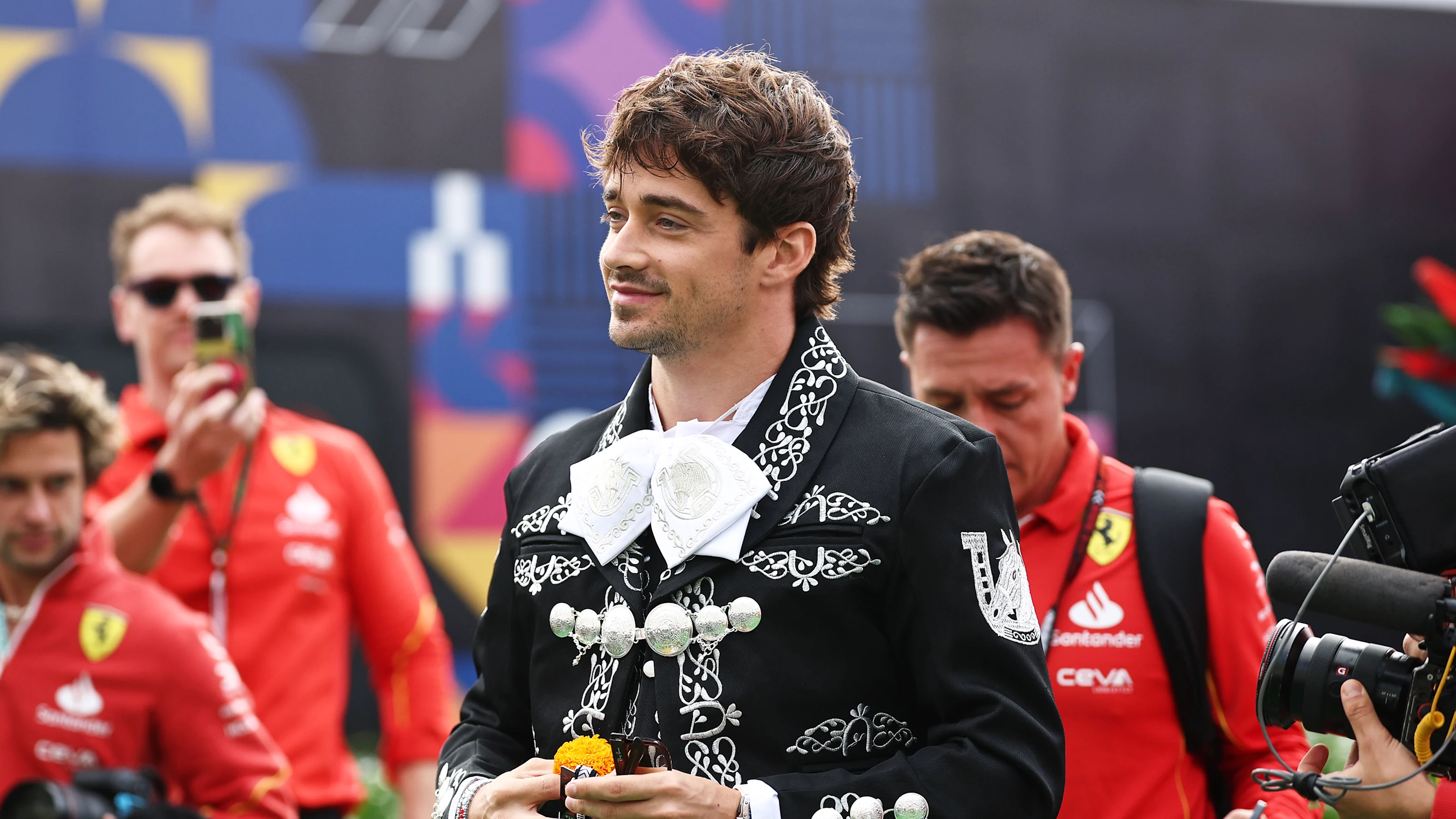 MEXICO CITY, MEXICO - OCTOBER 24: Charles Leclerc of Monaco and Ferrari walks in the Paddock during