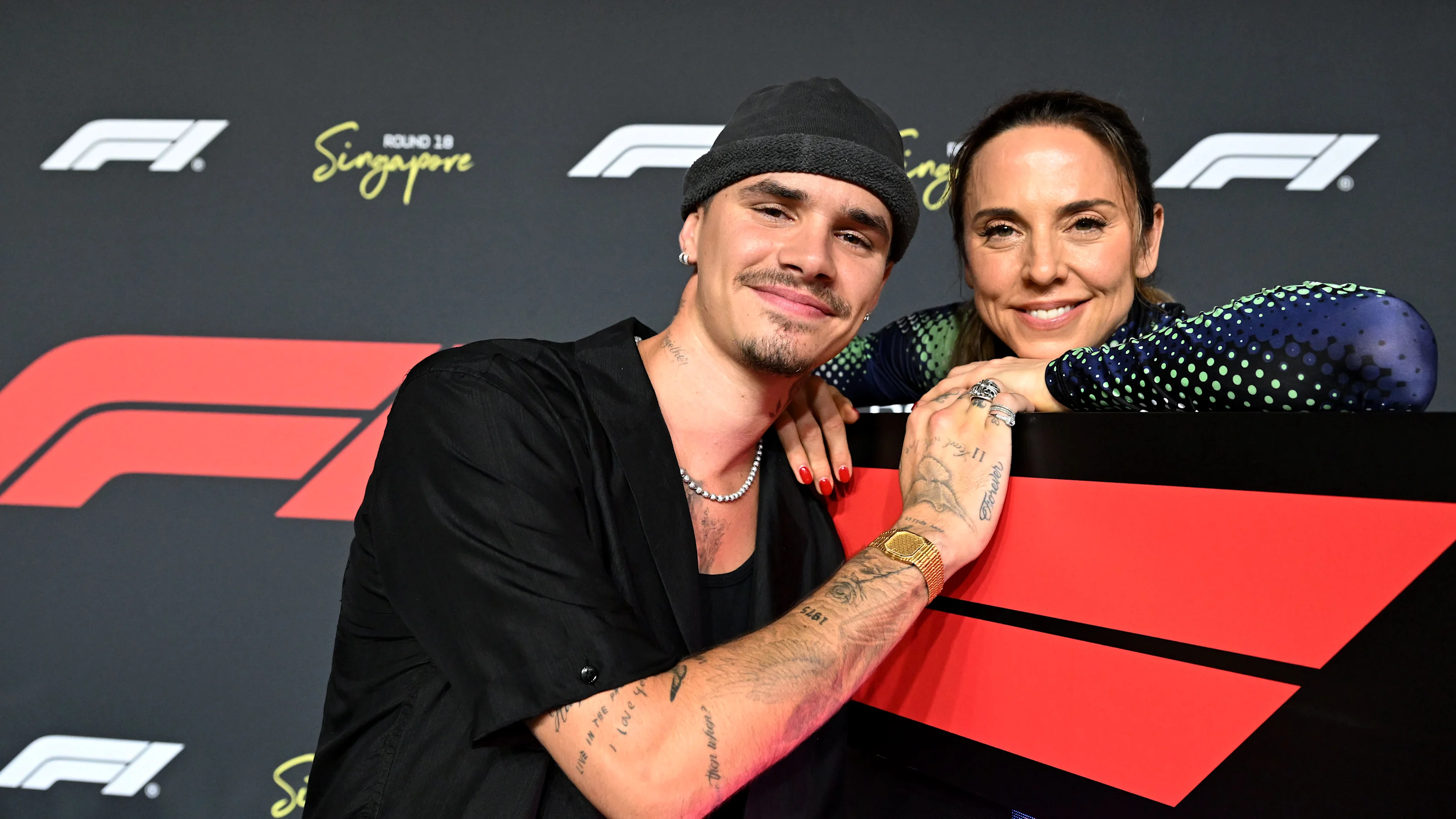 SINGAPORE, SINGAPORE - OCTOBER 05: Romeo Beckham and Melanie C on the grid during the F1 Grand Prix
