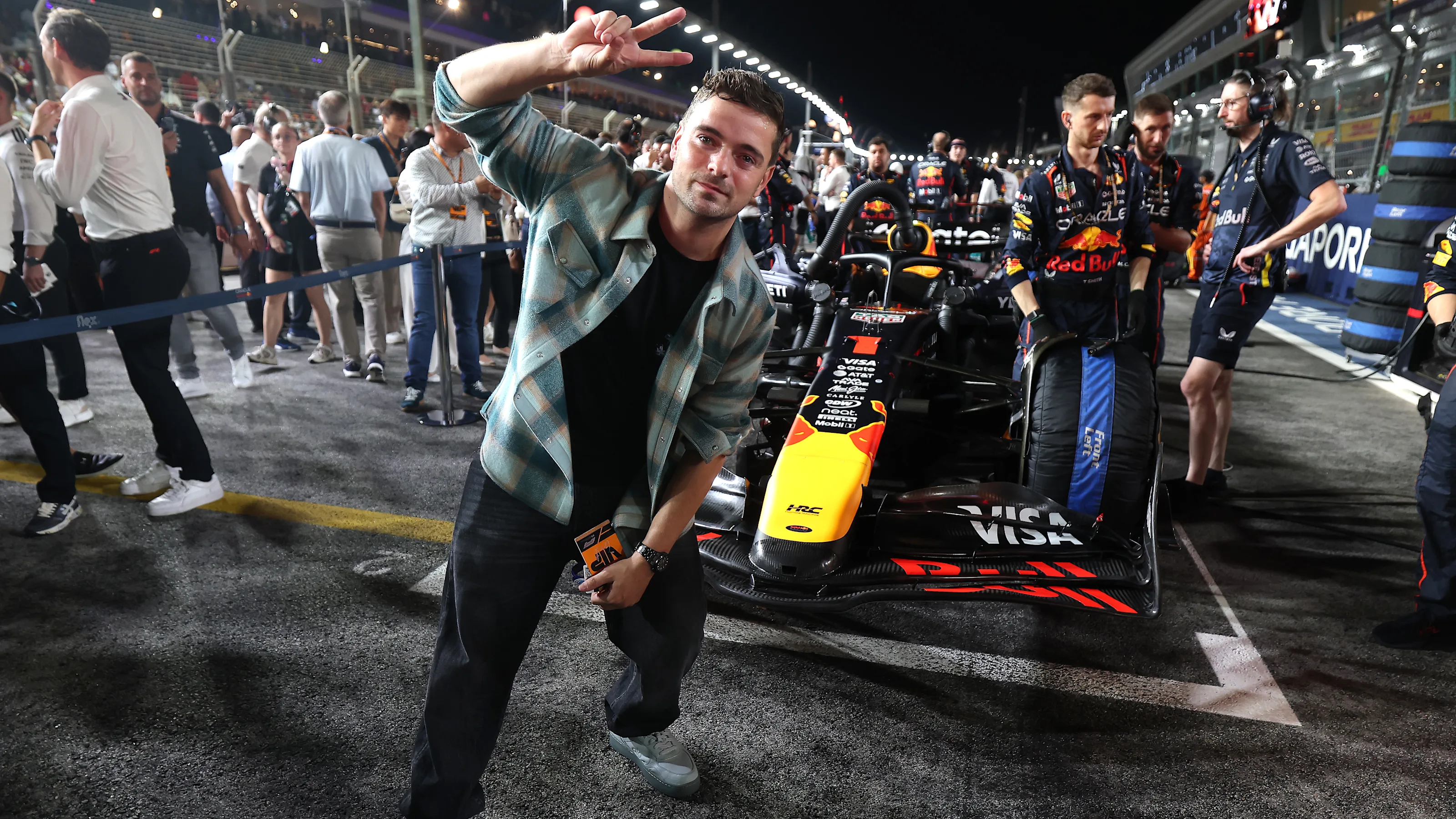 SINGAPORE, SINGAPORE - OCTOBER 05: Martin Garrix on the grid with the car of Max Verstappen of the