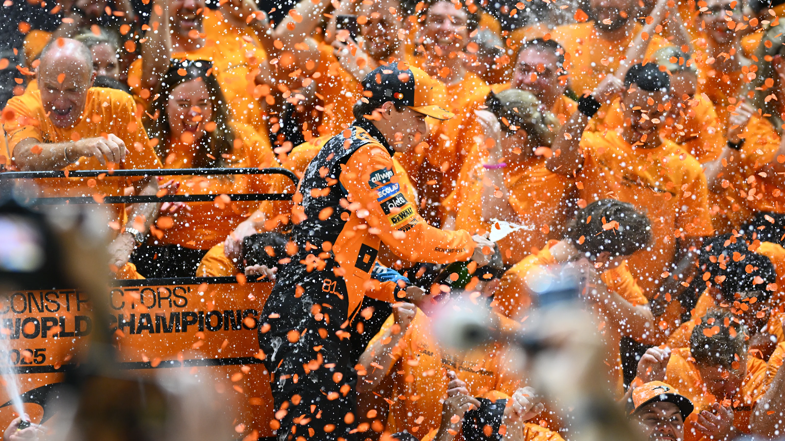 SINGAPORE, SINGAPORE - OCTOBER 05: Oscar Piastri of Australia and McLaren celebrates with his team