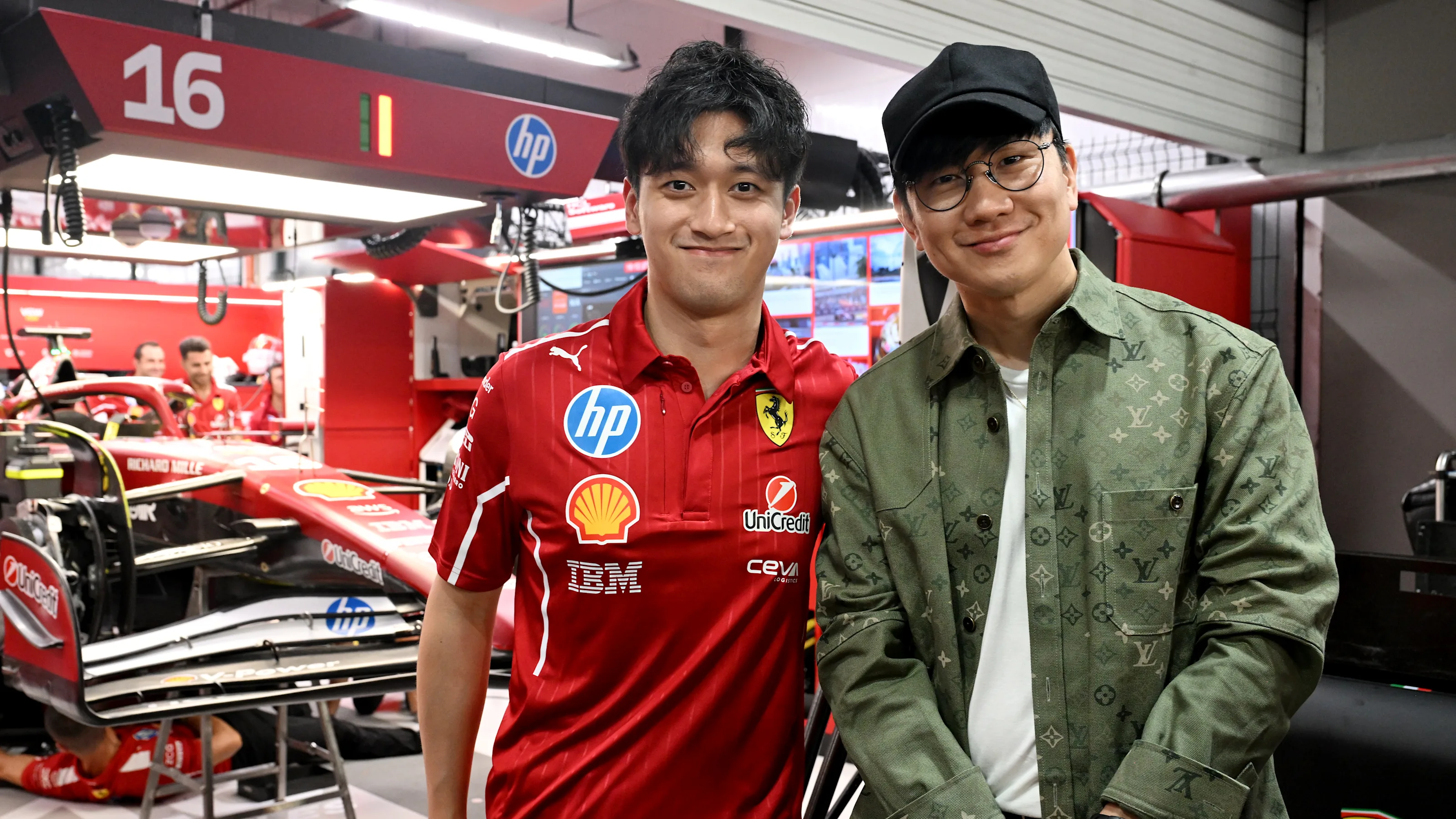 SINGAPORE, SINGAPORE - OCTOBER 04: JJ Lin and Zhou Guanyu of China and Scuderia Ferrari during