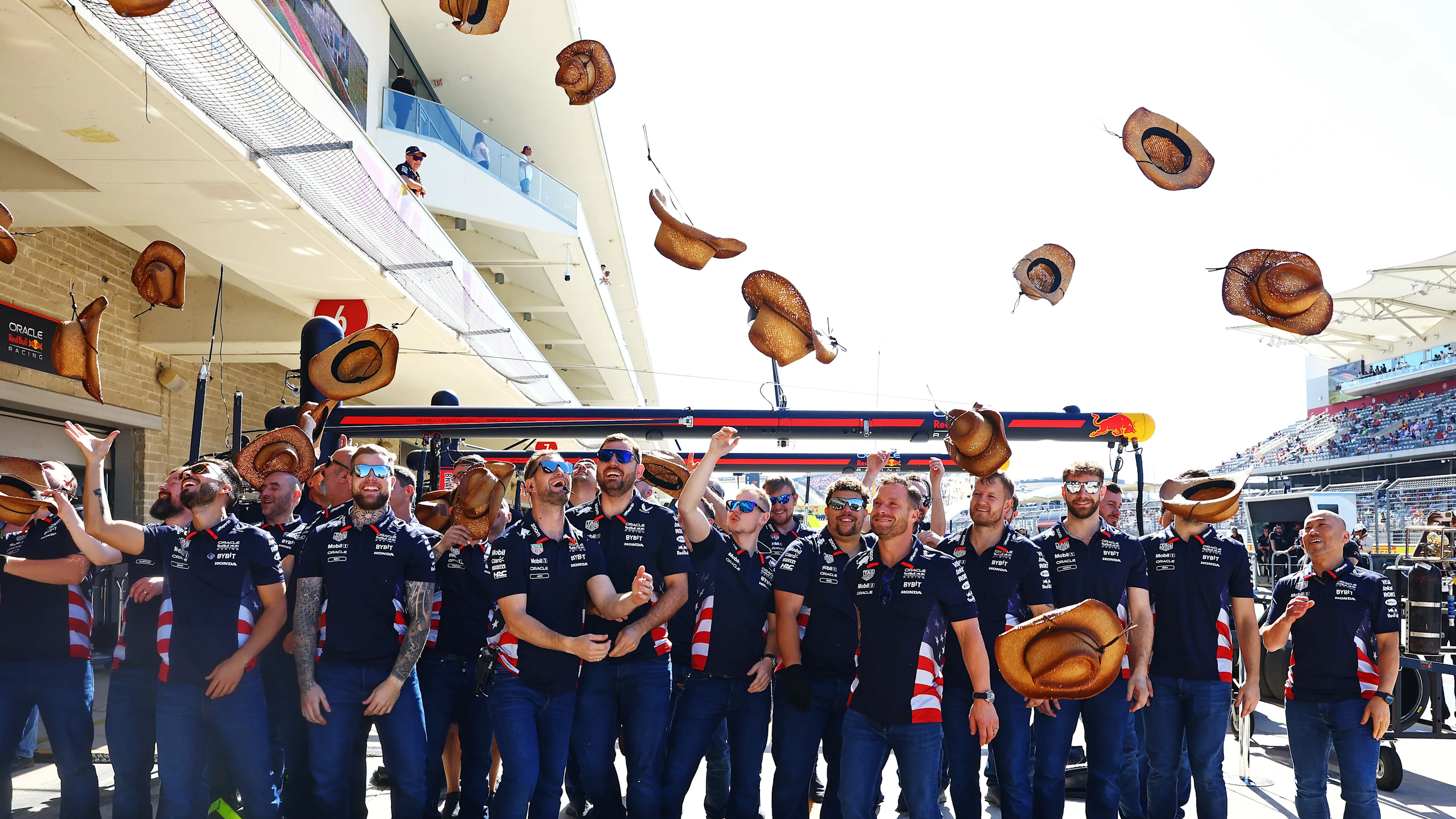 AUSTIN, TEXAS - OCTOBER 20: The Oracle Red Bull Racing team throw their cowboy hats in the air