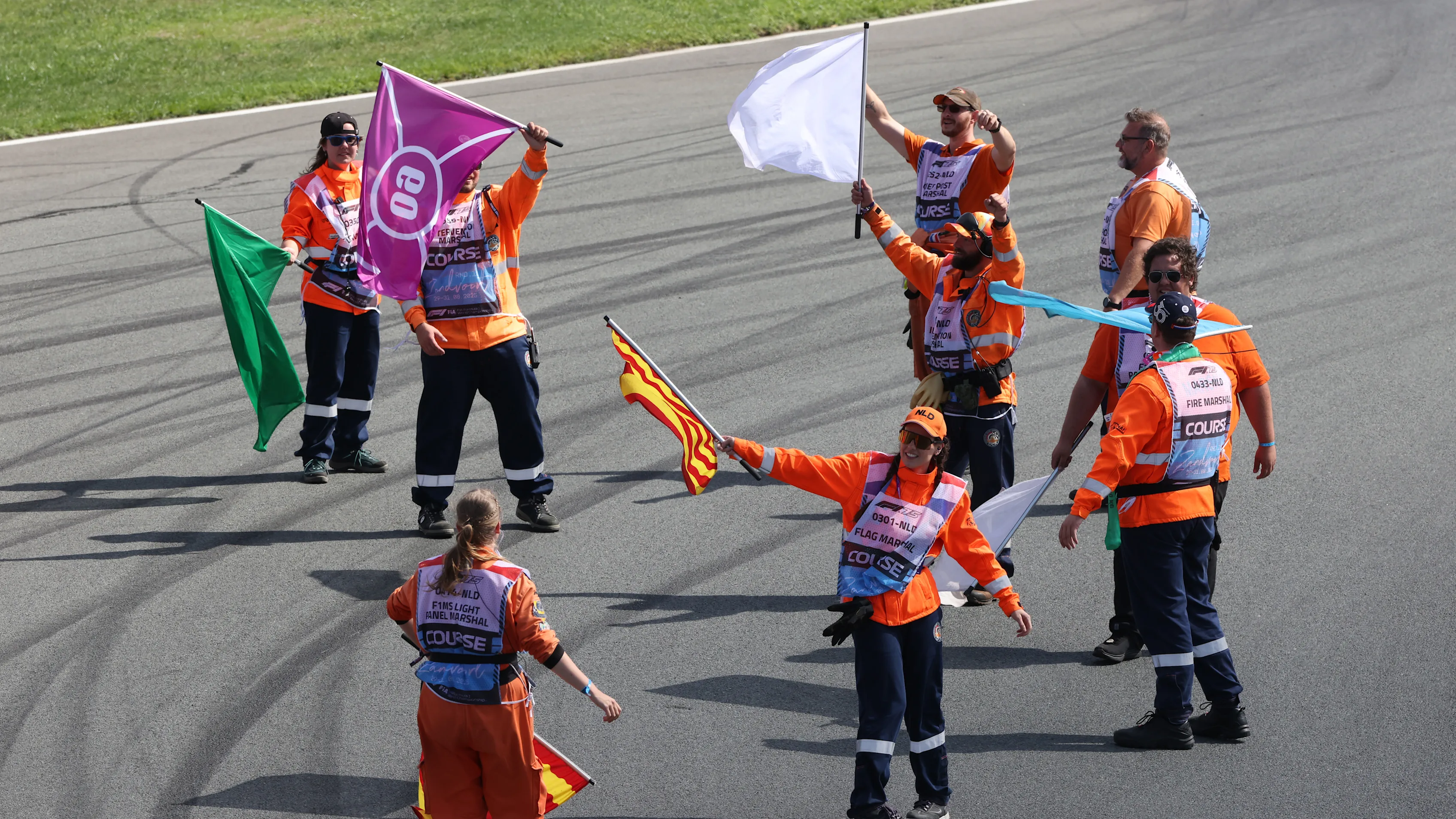 ZANDVOORT, NETHERLANDS - AUGUST 30: Marshals wave flags on track in celebration during qualifying