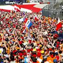 The Orange Army flood the track to celebrate Verstappen's victory at the Red Bull Ring during the 2019 Austrian Grand Prix