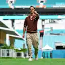 MIAMI, FLORIDA - MAY 02: Daniel Ricciardo of Australia and Visa Cash App RB walks in the Paddock