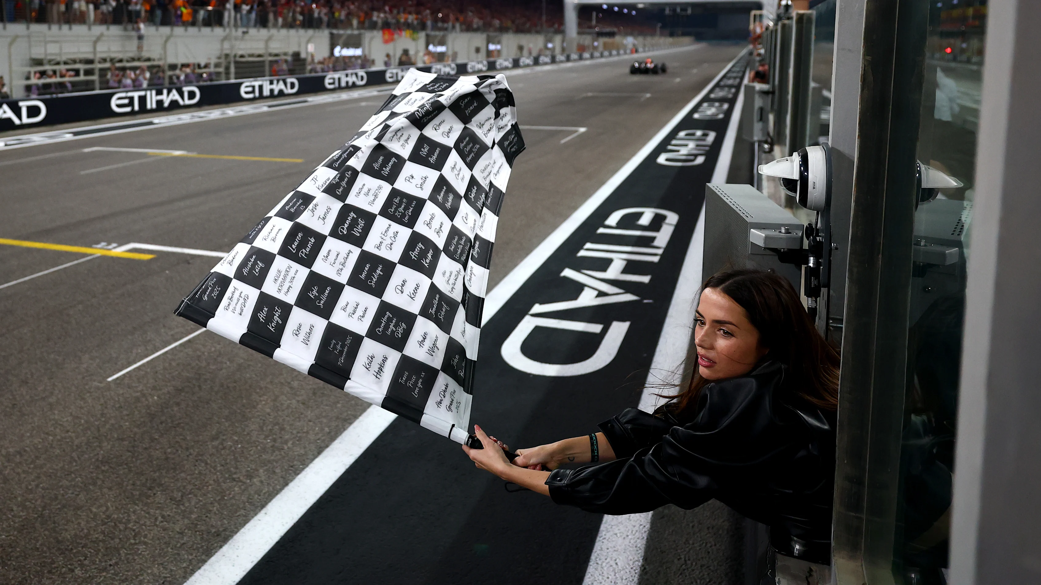 ABU DHABI, UNITED ARAB EMIRATES - DECEMBER 07: Ana de Armas waves the chequered flag during the F1