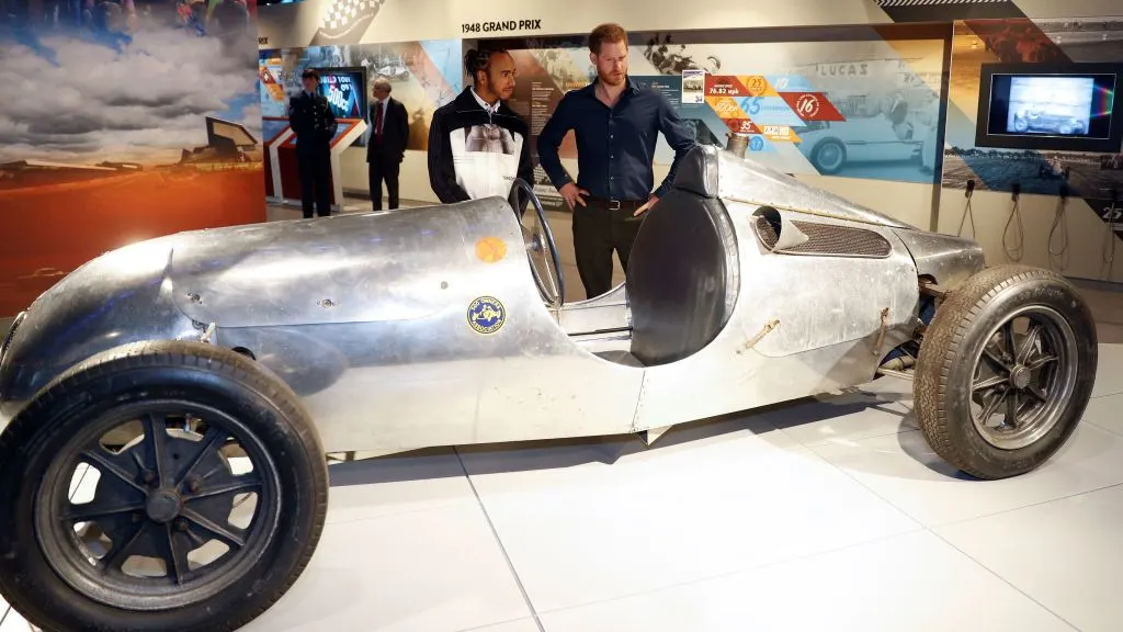 Britain's Prince Harry, Duke of Sussex (C) speaks with Britain's Formula One world champion driver