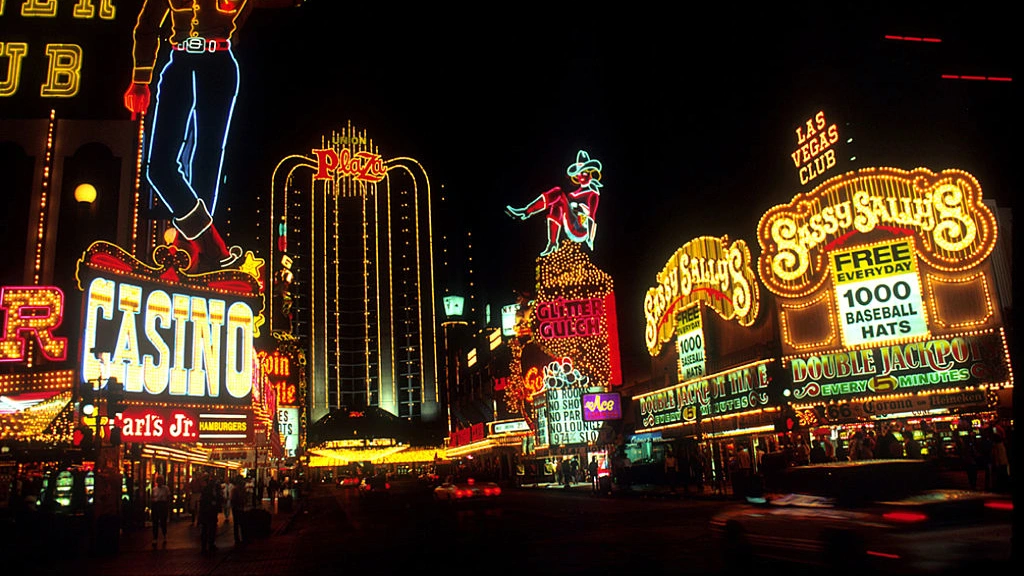View along of hotels, casinos, and their neon signs along Fremont Street, Las Vegas, Nevada, 1980s