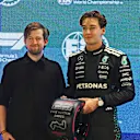 Alan Walker and George Russell after he took pole position in qualifying on Saturday
