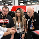 Ayao Komatsu gives a tour of the Haas garage to the Smashing Pumpkins ahead of the race