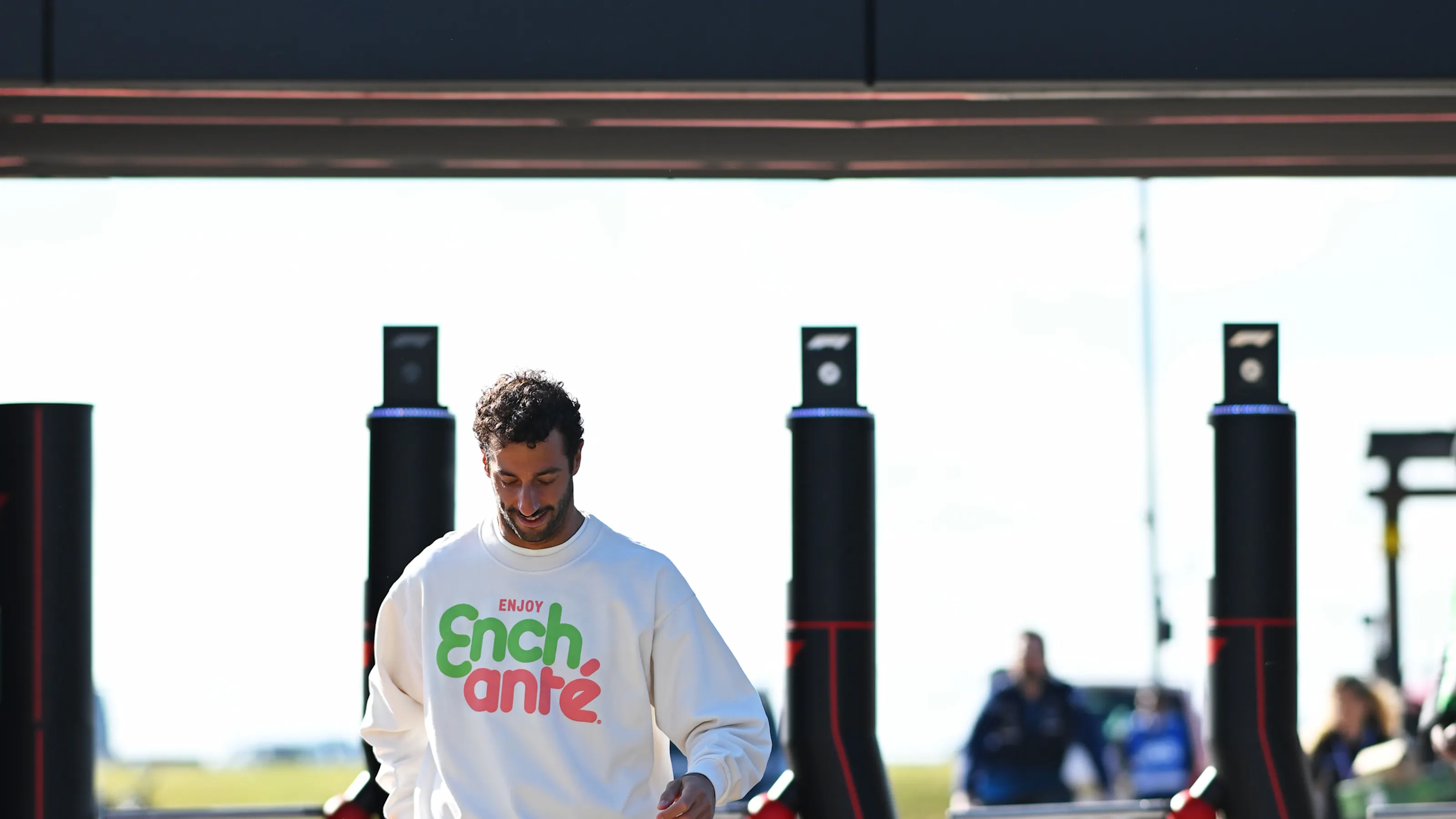 NORTHAMPTON, ENGLAND - JULY 04: Daniel Ricciardo of Australia and Visa Cash App RB walks in the