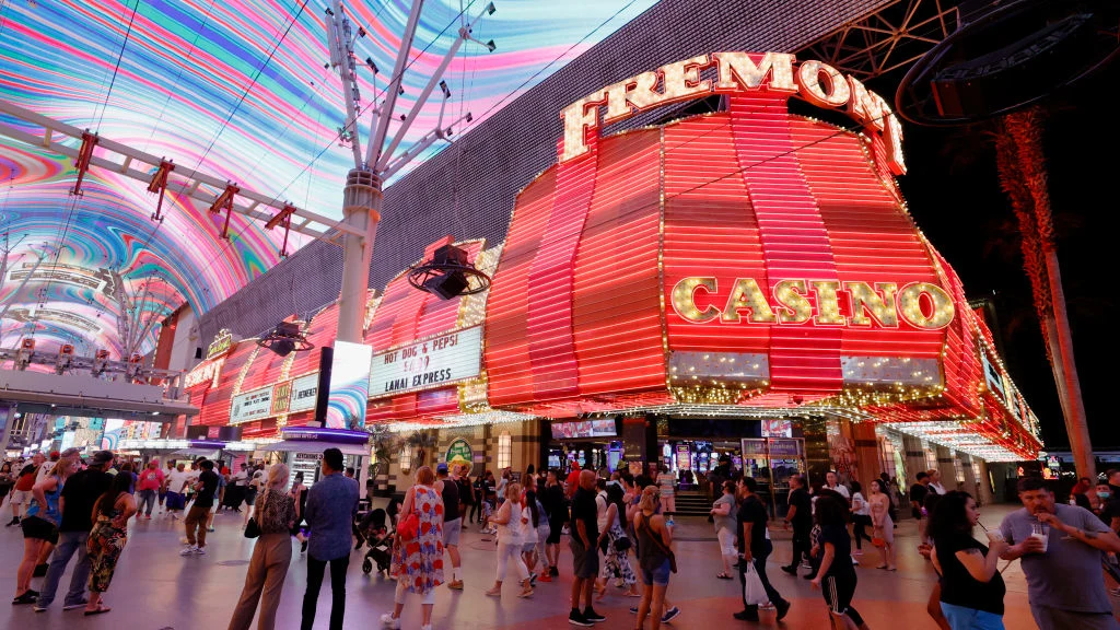 LAS VEGAS, NEVADA - MAY 31: Visitors walk by the Fremont Hotel & Casino under the Viva Vision
