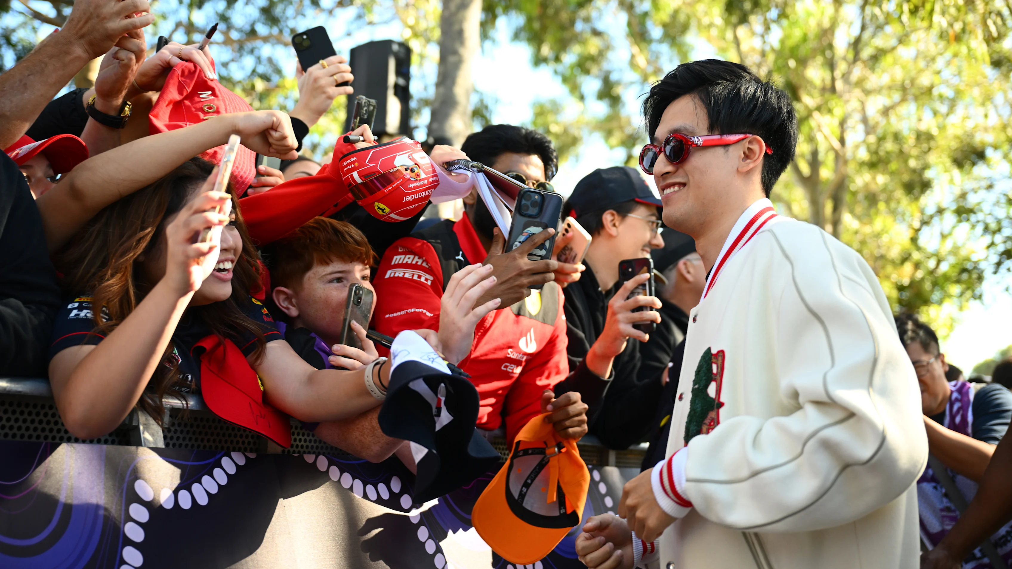 MELBOURNE, AUSTRALIA - MARCH 21: Zhou Guanyu of China and Stake F1 Team Kick Sauber greets fans on