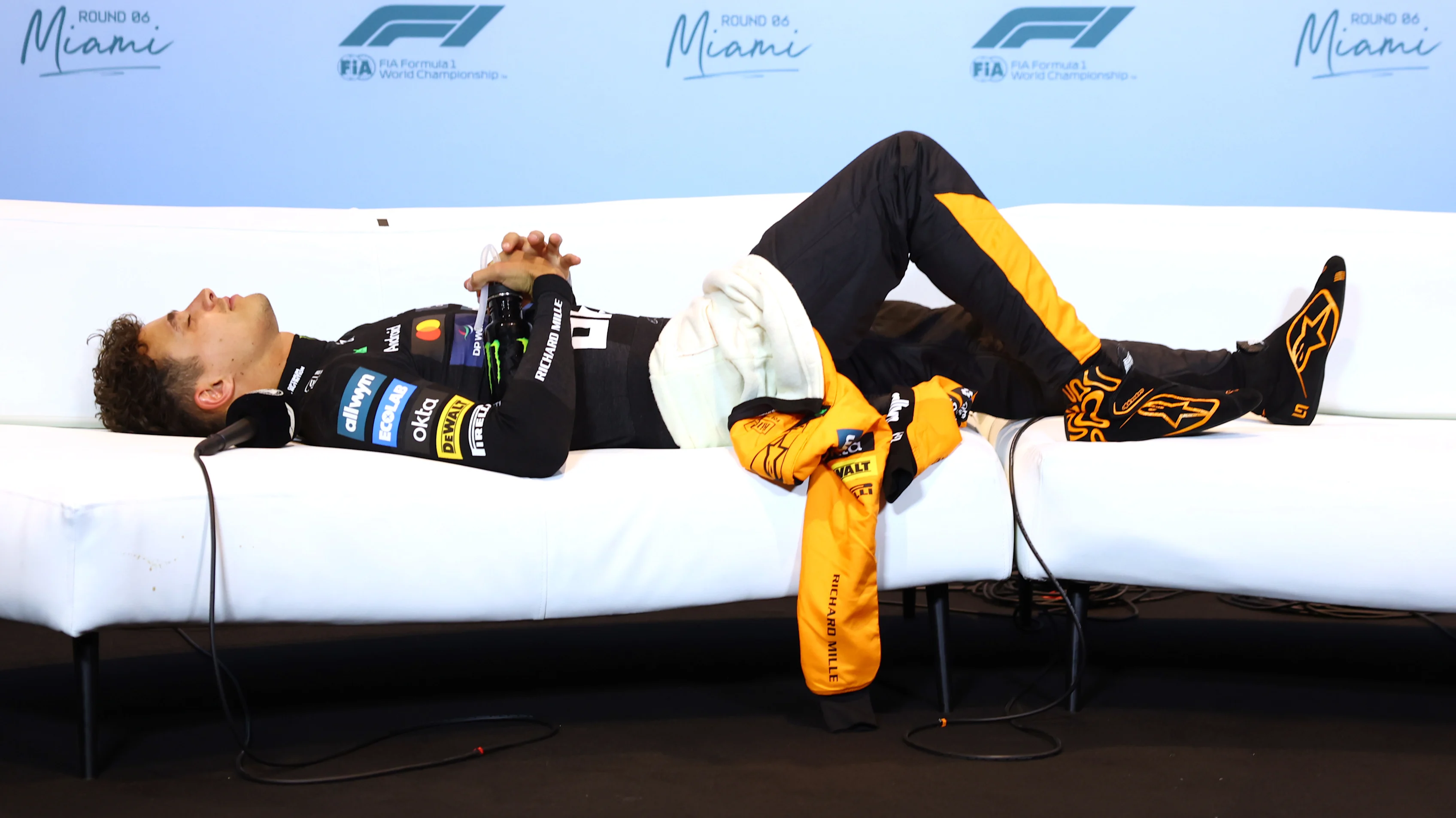 MIAMI, FLORIDA - MAY 04: Second placed Lando Norris of Great Britain and McLaren lays down in the