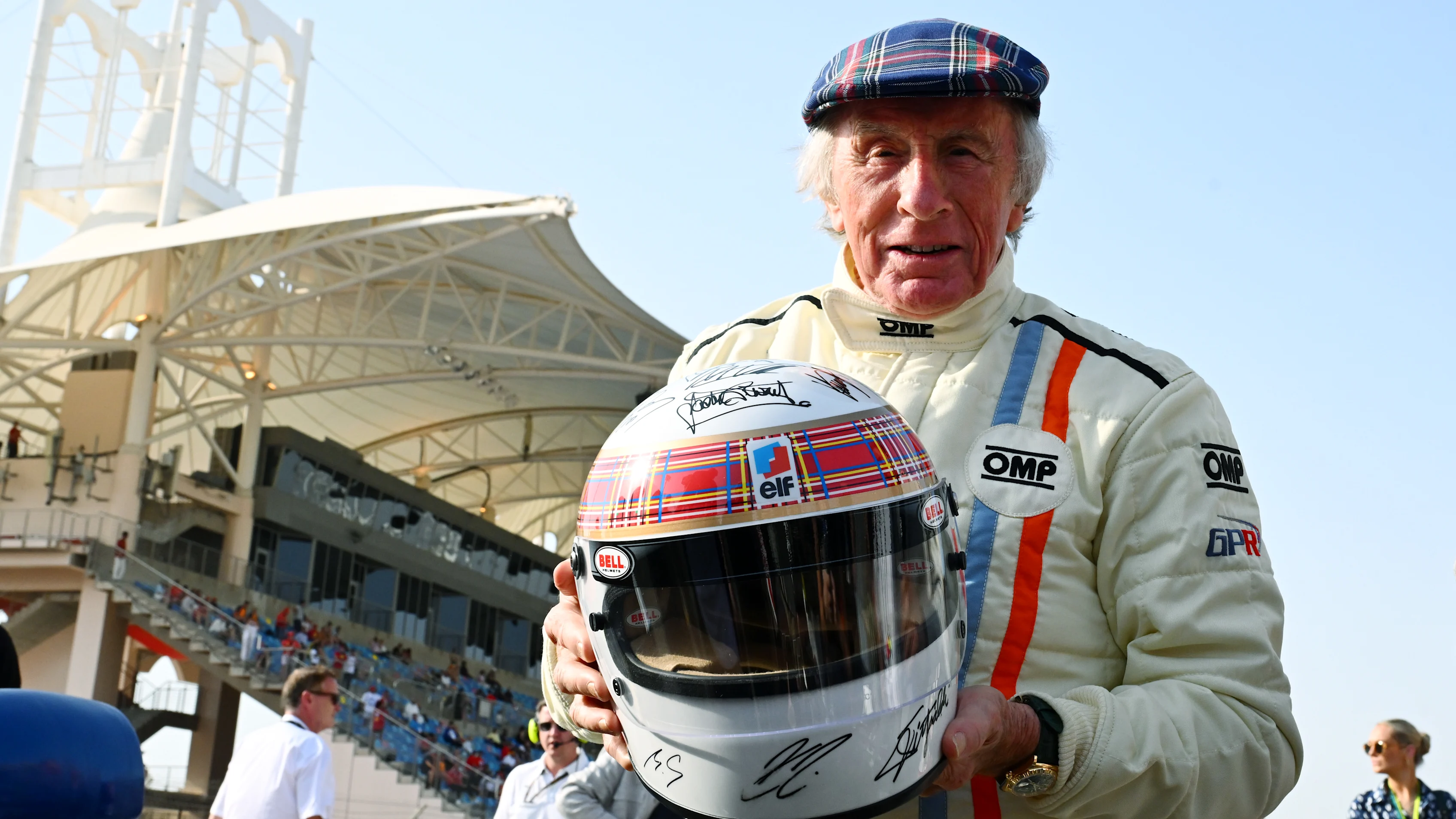 Sir Jackie Stewart and his signature Tartan helmet. Swipe for more images