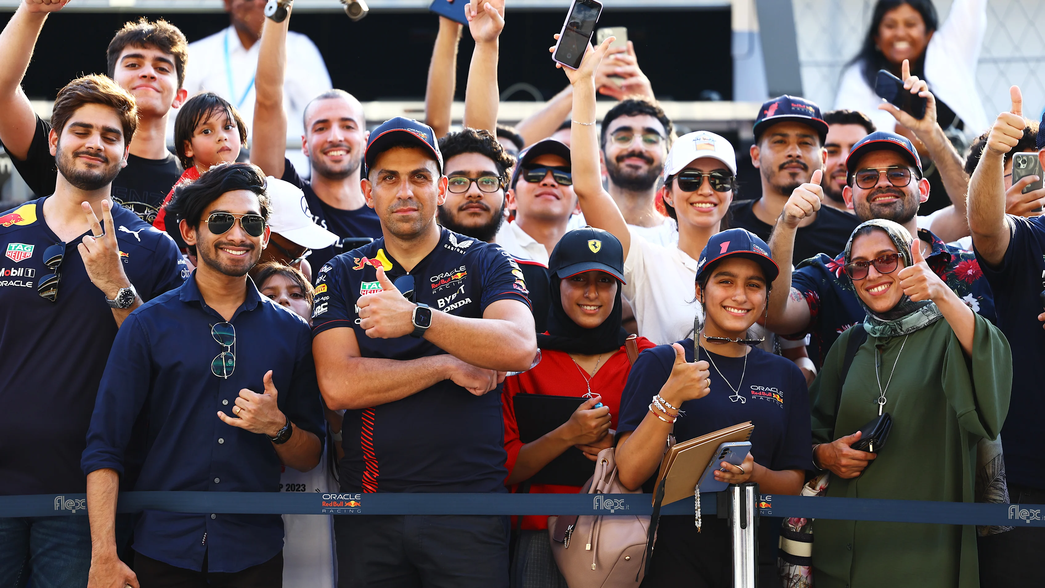 LUSAIL CITY, QATAR - OCTOBER 05: Red Bull Racing fans wait in the Pitlane during previews ahead of