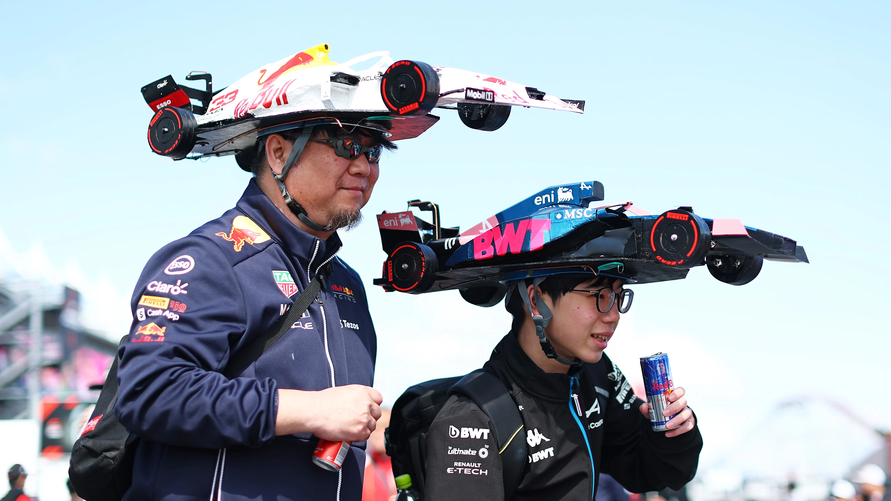 SUZUKA, JAPAN - APRIL 04: Fans of Oracle Red Bull Racing and Alpine F1 with custom hats prior to