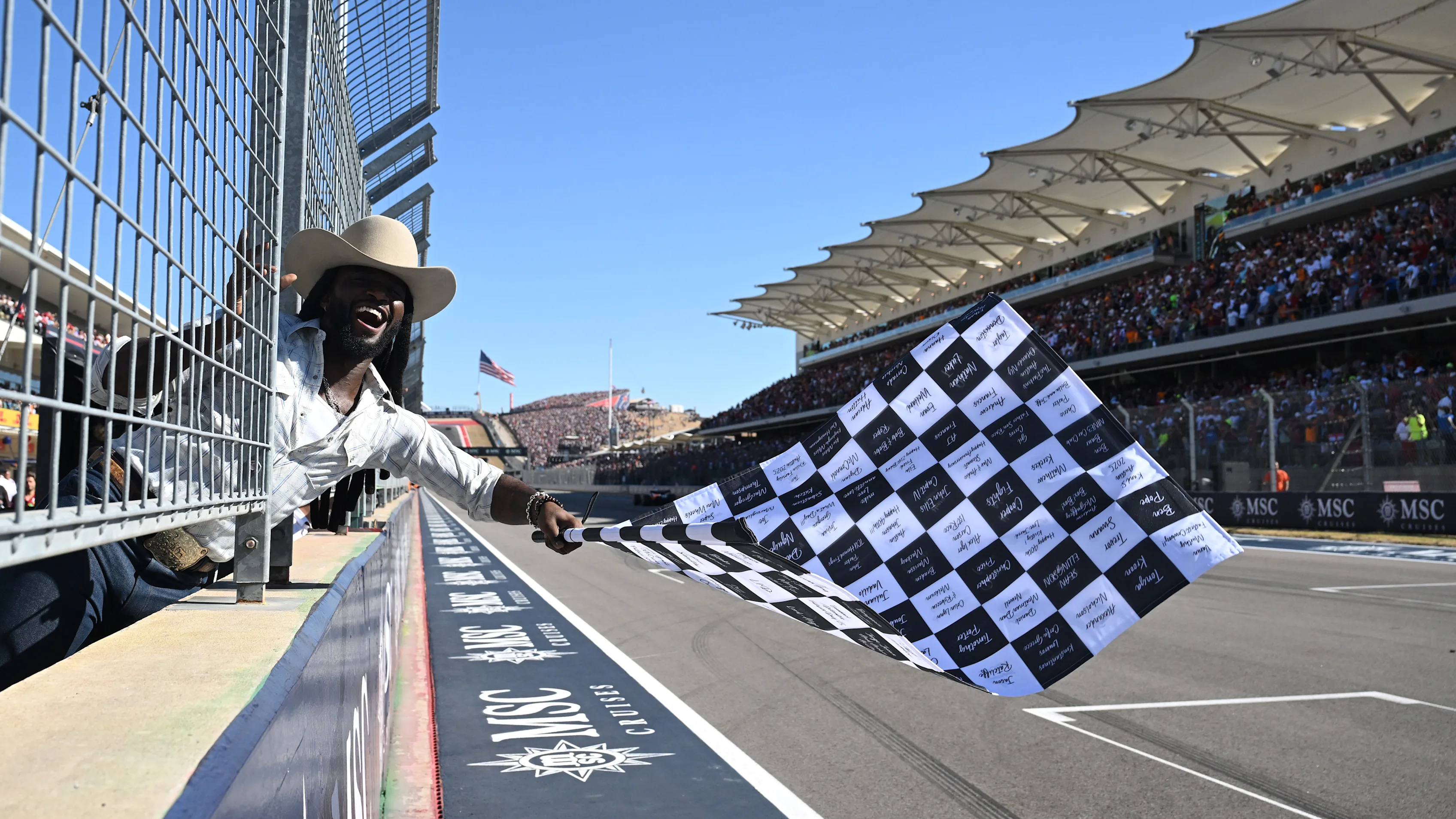 Country star Shaboozey must have been feeling ‘tipsy’ with excitement as he brought out the chequered flag at COTA. Swipe for more images