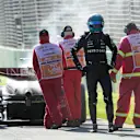 Mercedes' British driver George Russell walks back to the pits after his car caught fire during the 2023 Formula One Australian Grand Prix at the Albert Park Circuit in Melbourne on April 2, 2023. (Photo by Simon Baker / POOL / AFP) / -- IMAGE RESTRICTED TO EDITORIAL USE - STRICTLY NO COMMERCIAL USE -- (Photo by SIMON BAKER/POOL/AFP via Getty Images)