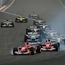 Michael Schumacher (GER) Ferrari F2004 and Rubens Barrichello (BRA) Ferrari F2004 both lock up at the start of the race. Formula One World Championship, Rd3, Bahrain Grand Prix, Race Day, Bahrain International Circuit, Bahrain, 4 April 2004 © Sutton Images. No reproduction without permission