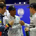 (L to R): Daniel Ricciardo (AUS) Red Bull Racing, pole sitter Lewis Hamilton (GBR) Mercedes AMG F1 and Nico Rosberg (GER) Mercedes AMG F1 celebrate in parc ferme. Formula One World Championship, Rd14, Singapore Grand Prix, Marina Bay Street Circuit, Singapore, Qualifying, Saturday, 20 September 2014 