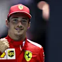 SINGAPORE, SINGAPORE - SEPTEMBER 21: Pole position qualifier Charles Leclerc of Monaco and Ferrari celebrates in parc ferme during qualifying for the F1 Grand Prix of Singapore at Marina Bay Street Circuit on September 21, 2019 in Singapore. (Photo by Mark Thompson/Getty Images)
