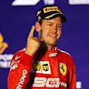 SINGAPORE, SINGAPORE - SEPTEMBER 22: Race winner Sebastian Vettel of Germany and Ferrari celebrates on the podium during the F1 Grand Prix of Singapore at Marina Bay Street Circuit on September 22, 2019 in Singapore. (Photo by Mark Thompson/Getty Images)