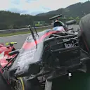 Fernando Alonso's McLaren ended up parked on the barriers after a collision with Ferrari's Kimi Raikkonen on lap one in Austria