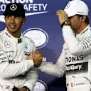 (L to R): Pole sitter Lewis Hamilton (GBR) Mercedes AMG F1 and Nico Rosberg (GER) Mercedes AMG F1 celebrate in parc ferme at Formula One World Championship, Rd4, Bahrain Grand Prix Qualifying, Bahrain International Circuit, Sakhir, Bahrain, Saturday 18  April 2015. © Sutton Motorsport Images