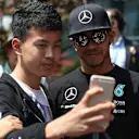 Lewis Hamilton (GBR) Mercedes AMG F1 poses for a selfie with a fan at Formula One World Championship, Rd3, Chinese Grand Prix, Qualifying, Shanghai, China, Saturday 11 April 2015. © Sutton Motorsport Images