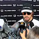 Fernando Alonso (ESP) McLaren talks with the media as Silvia Hoffer Frangipane, McLaren Press Officer looks on at Formula One World Championship, Rd10, Hungarian Grand Prix, Qualifying, Hungaroring, Hungary, Saturday 25 July 2015. © Sutton Motorsport Images
