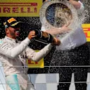 Race winner Lewis Hamilton (GBR) Mercedes AMG F1 and Ron Meadows (GBR) Mercedes AMG F1 Team Manager celebrate on the podium with the champagne and the trophy at Formula One World Championship, Rd11, Hungarian Grand Prix, Race, Hungaroring, Hungary, Sunday 24 July 2016. © Sutton Images