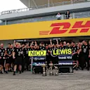Mercedes AMG F1 mechanics and engineers celebrate the constructors championship with the trophy at Formula One World Championship, Rd17, Japanese Grand Prix, Race, Suzuka, Japan, Sunday 9 October 2016. © Sutton Images