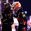 ABU DHABI, UNITED ARAB EMIRATES - DECEMBER 12: Pole position qualifier Max Verstappen of Netherlands and Red Bull Racing is congratulated by third placed qualifier Lewis Hamilton of Great Britain and Mercedes GP in parc ferme during qualifying ahead of the F1 Grand Prix of Abu Dhabi at Yas Marina Circuit on December 12, 2020 in Abu Dhabi, United Arab Emirates. (Photo by Mario Renzi - Formula 1/Formula 1 via Getty Images)