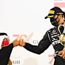 BAHRAIN, BAHRAIN - NOVEMBER 29: Race winner Lewis Hamilton of Great Britain and Mercedes GP celebrates on the podium during the F1 Grand Prix of Bahrain at Bahrain International Circuit on November 29, 2020 in Bahrain, Bahrain. (Photo by Clive Mason - Formula 1/Formula 1 via Getty Images)