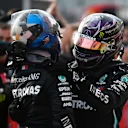 IMOLA, ITALY - NOVEMBER 01: Race winner Lewis Hamilton of Great Britain and Mercedes GP (R) embraces teammate and second placed Valtteri Bottas of Finland and Mercedes GP (L) in parc ferme during the F1 Grand Prix of Emilia Romagna at Autodromo Enzo e Dino Ferrari on November 01, 2020 in Imola, Italy. (Photo by Rudy Carezzevoli/Getty Images)