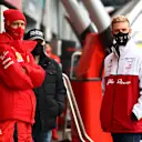 NUERBURG, GERMANY - OCTOBER 09: Sebastian Vettel of Germany and Ferrari and Mick Schumacher of Germany and Alfa Romeo Racing talk in the Pitlane during a weather delayed FP2 during practice ahead of the F1 Eifel Grand Prix at Nuerburgring on October 09, 2020 in Nuerburg, Germany. (Photo by Mark Thompson/Getty Images)