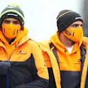 NUERBURG, GERMANY - OCTOBER 08: Lando Norris of Great Britain and McLaren F1 and Carlos Sainz of Spain and McLaren F1 walk in the Paddock during previews ahead of the F1 Eifel Grand Prix at Nuerburgring on October 08, 2020 in Nuerburg, Germany. (Photo by Mark Thompson/Getty Images)