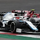 PORTIMAO, PORTUGAL - OCTOBER 25: George Russell of Great Britain driving the (63) Williams Racing FW43 Mercedes and Antonio Giovinazzi of Italy driving the (99) Alfa Romeo Racing C39 Ferrari battle for position on track during the F1 Grand Prix of Portugal at Autodromo Internacional do Algarve on October 25, 2020 in Portimao, Portugal. (Photo by Joe Portlock/Getty Images)