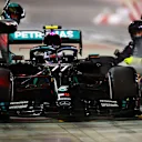 BAHRAIN, BAHRAIN - DECEMBER 06: Valtteri Bottas of Finland driving the (77) Mercedes AMG Petronas F1 Team Mercedes W11 makes a pitstop as smoke pour from his front left brake during the F1 Grand Prix of Sakhir at Bahrain International Circuit on December 06, 2020 in Bahrain, Bahrain. (Photo by Mark Thompson/Getty Images)