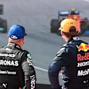 SPIELBERG, AUSTRIA - JULY 04: Race winner Max Verstappen of Netherlands and Red Bull Racing and second placed Valtteri Bottas of Finland and Mercedes GP talk in parc ferme during the F1 Grand Prix of Austria at Red Bull Ring on July 04, 2021 in Spielberg, Austria. (Photo by Mark Thompson/Getty Images)