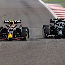 BAHRAIN, BAHRAIN - MARCH 28: Sergio Perez of Mexico driving the (11) Red Bull Racing RB16B Honda and Sebastian Vettel of Germany driving the (5) Aston Martin AMR21 Mercedes compete for position on track during the F1 Grand Prix of Bahrain at Bahrain International Circuit on March 28, 2021 in Bahrain, Bahrain. (Photo by Bryn Lennon/Getty Images)