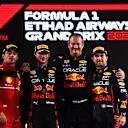 ABU DHABI, UNITED ARAB EMIRATES - NOVEMBER 20: Race winner Max Verstappen of the Netherlands and Oracle Red Bull Racing, second placed Charles Leclerc of Monaco and Ferrari, Olaf Janssen, Red Bull Racing Team Member and Third placed Sergio Perez of Mexico and Oracle Red Bull Racing celebrate on the podium during the F1 Grand Prix of Abu Dhabi at Yas Marina Circuit on November 20, 2022 in Abu Dhabi, United Arab Emirates. (Photo by Rudy Carezzevoli/Getty Images)