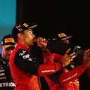 BAHRAIN, BAHRAIN - MARCH 20: Race winner Charles Leclerc of Monaco and Ferrari celebrates on the podium during the F1 Grand Prix of Bahrain at Bahrain International Circuit on March 20, 2022 in Bahrain, Bahrain. (Photo by Clive Mason/Getty Images)